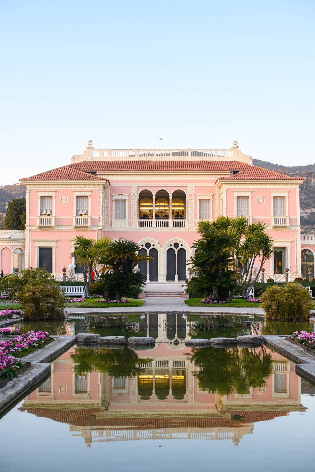 Villa Ephrussi de Rothschild reflected in the French garden pool during evening light
